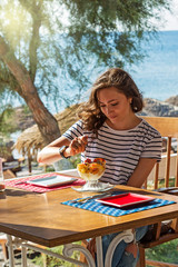 Young woman at the beach cafe