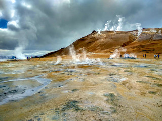 Valley of geysers in Iceland, in the air a lot of steam over the valley