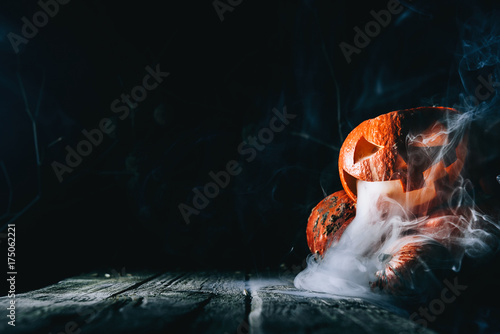 Pumpkin to celebrate Halloween on a wooden background