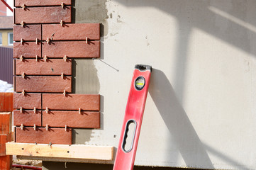 The building under construction. Walls under construction are insulated and plastered. Building...