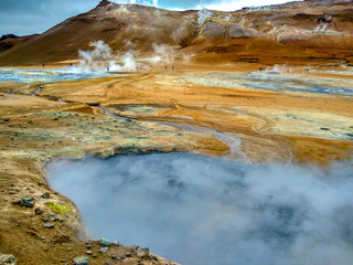 Valley of geysers in Iceland, in the air a lot of steam over the valley