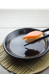Hand using chopsticks pick Sushi
