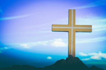 cross on blurry sunset background. Christian, Christianity, Religion copyspace background.
