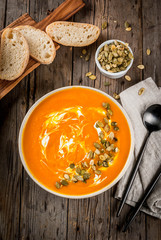Traditional fall and winter dishes, hot and spicy pumpkin  soup with pumpkin seeds, cream and...