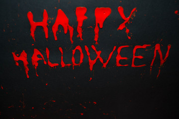 Happy halloween red words on black background. Happy Halloween text with paint or spray. Halloween inscription. Banner.
