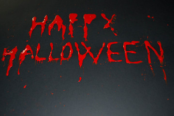 Happy halloween red words on black background. Happy Halloween text with paint or spray. Halloween...