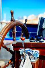 Closeup view on steering wheel of the ship, background outdoors © gorosi