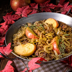 Fried liver with onion apple and herbs.
