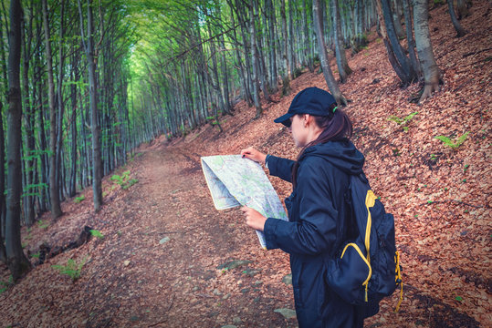 girl with map in forest
