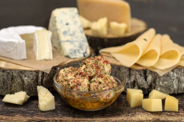 Cheeses on a wooden board. 