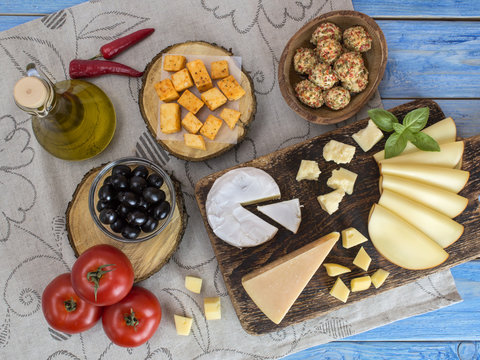 Cheeses on a wooden board. 