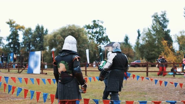 Medieval tournament and competition between two strong knights with steel swords