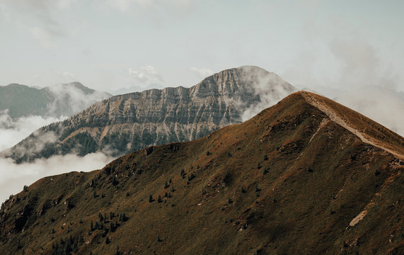 Fototapeta Minimalist landscape of  mountains. Mountain peaks in the clouds