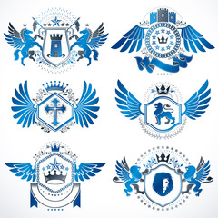 Heraldic vector signs decorated with vintage elements, monarch crowns, religious crosses, armory and animals. Set of classy symbolic graphic insignias with bird wings.