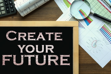 Text Create your future on the blackboard on the desk with office business accessories