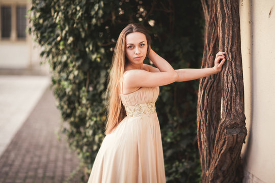 Beautiful girl with long hair posing near tree in vavel Krakow