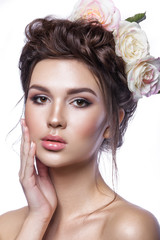 Naklejka premium Beauty young girl, clean skin, beautiful make-up, hairstyle braids and rose flowers in hair.