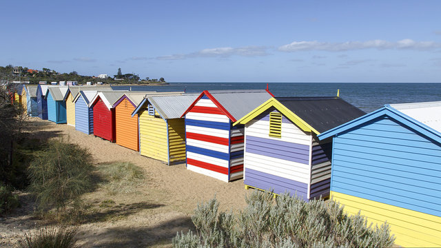 Row of iconic colourful beach huts at Brighton Beach in Melbourne