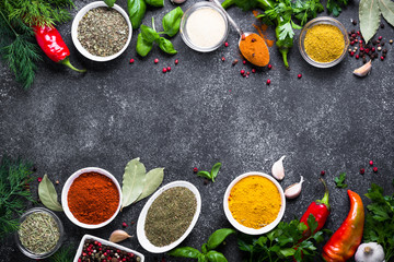 Set of Various spices and herbs on black stone table. 