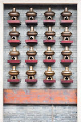 Bronze copper Hot-Pot decoration on a brick wall, China