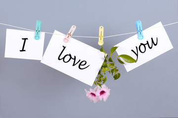 Words I love you on the white paper and hanging on the cord