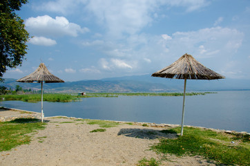 wooden sunshades on the shore of the lake