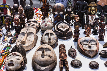 Wooden masks and figures of African culture at the flea market in Paris. France - 175075071