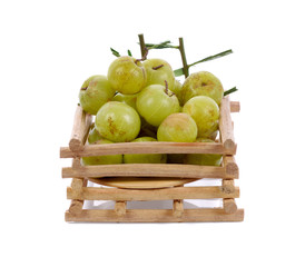 Indian gooseberry in bamboo basket isolated on white background
