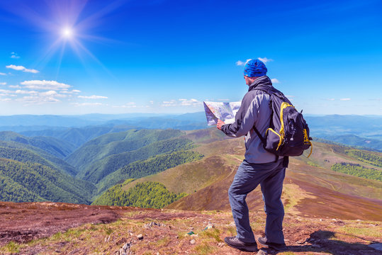 Tourist with a backpack and a map