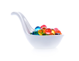 Colourful jelly in white spoon isolated over white background