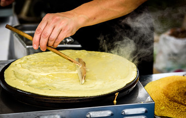 Making of crepes pancakes in open market festival fair. - obrazy, fototapety, plakaty