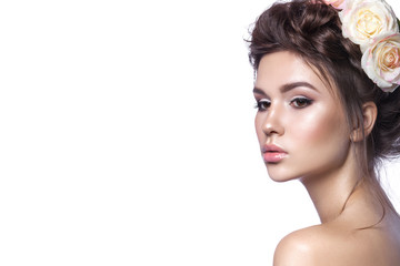 Obraz premium Beauty young girl, clean skin, beautiful make-up, hairstyle braids and rose flowers in hair.
