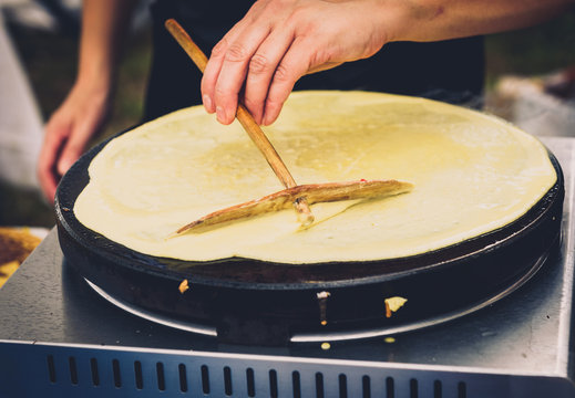 Making of crepes pancakes in open market festival fair.