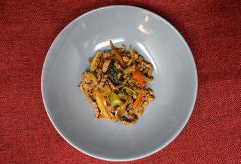 wok fried chicken stir fry with sweet peppers and chinese vegetables
