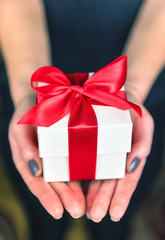 white gift in woman hands