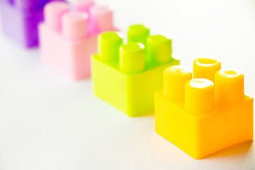 Multi color square plastic toy block on white background