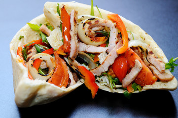 Stuffed pita, pita bread, filling, from vegetables and meat, bacon, tomato, onion, Bulgarian pepper, greens, basil. Eastern cuisine