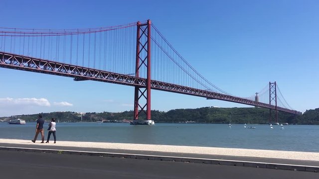 Couple Walking Along Tagus River In Lisbon. Lisbon is the capital and the largest city of Portugal