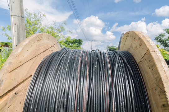 Electric Cable Roll Black Wire And Blue Sky Background