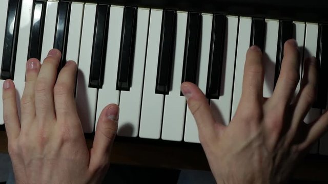 Piano playing top-view handheld stock footage 2160p