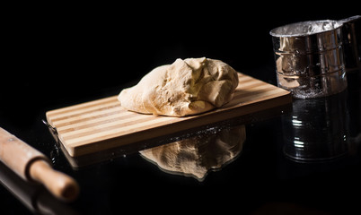 The man cook prepares flour products and meal-free flour on a glass table. Beautiful conceptual photo