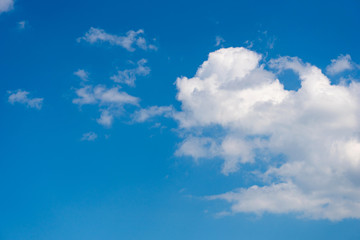 Naklejka na ściany i meble Sunny weather with cumulus clouds on blue sky