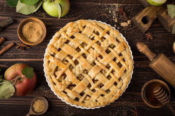 apple pie and ingredients on wooden background