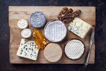 French Cheese Platter with Spanish Dulce de Membrillo as top view on a wooden board
