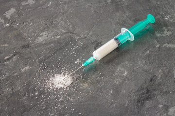 Sugar in a syringe. Conceptual depiction of dependence on the sweet. Sugar is a drug. Injection of...