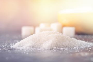 A pile of white sugar on a dark background.