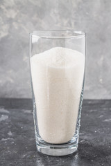 Glass with sugar sand is an unhealthy diet. The contents of sugar in sweet soda.
