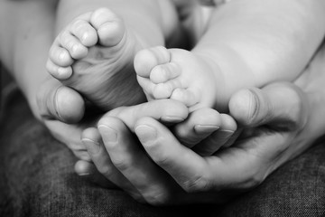 Baby's feet in mother's hands