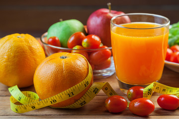 Healthy concept with mixed fruits and vegetables on wooden background
