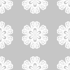 White floral ornament on gray background. Seamless pattern for textile and wallpapers